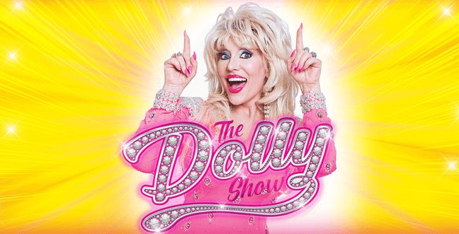 A Dolly Patron tribute with a pink dress, pink nails, and blonde hair stands in front of a yellow backdrop with the glittery pink title 'The Dolly Show'