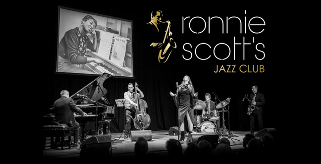 A jazz band on stage in the spotlight with a screen projected behind them. The title reads 'Ronnie Scott's Jazz Club'
