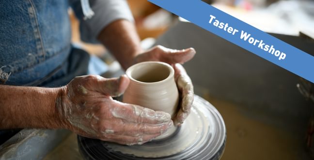A person throwing a pot on a potters wheel