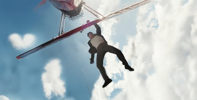 A man holding onto the outside of an airplane in the sky as it is flying.